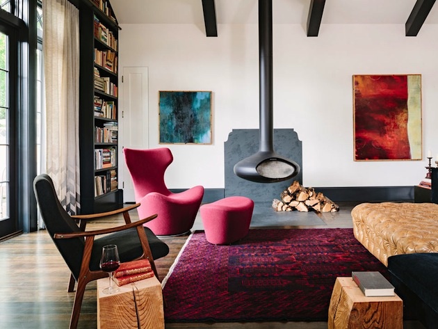 Ružové kreslo, taburetka a koberec rovnakej farby oživili izbu s prevažne tmavým nábytkom.