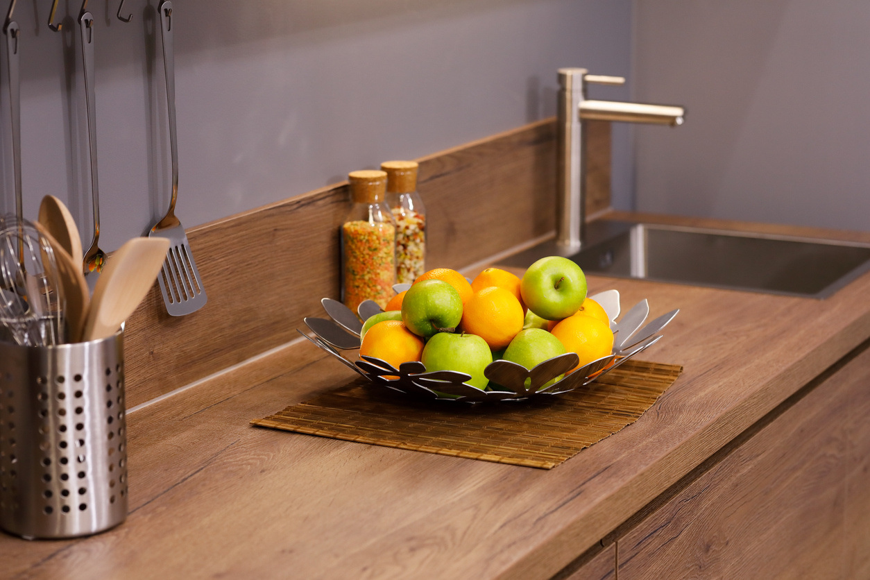 Apples and oranges on the wooden kitchen counter
