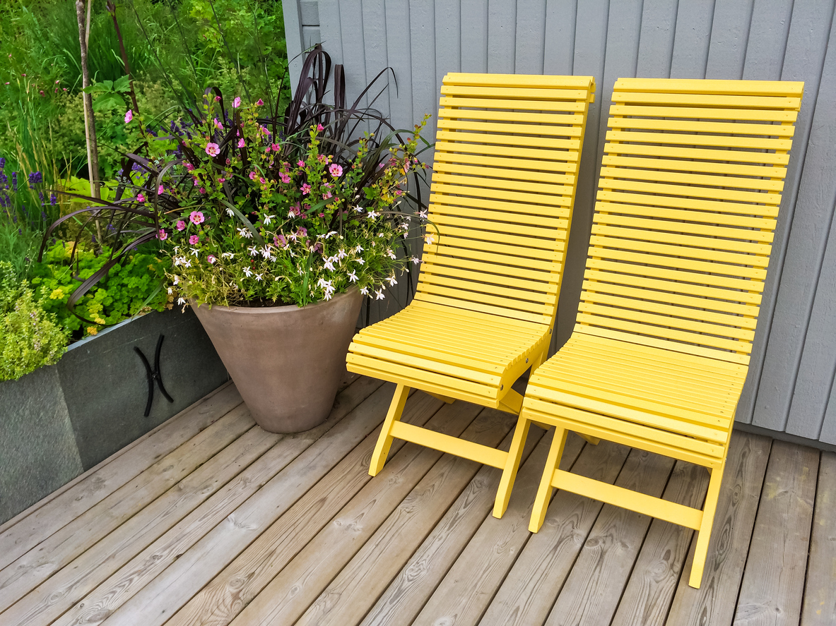 Yellow chairs and flowers decorating house exterior