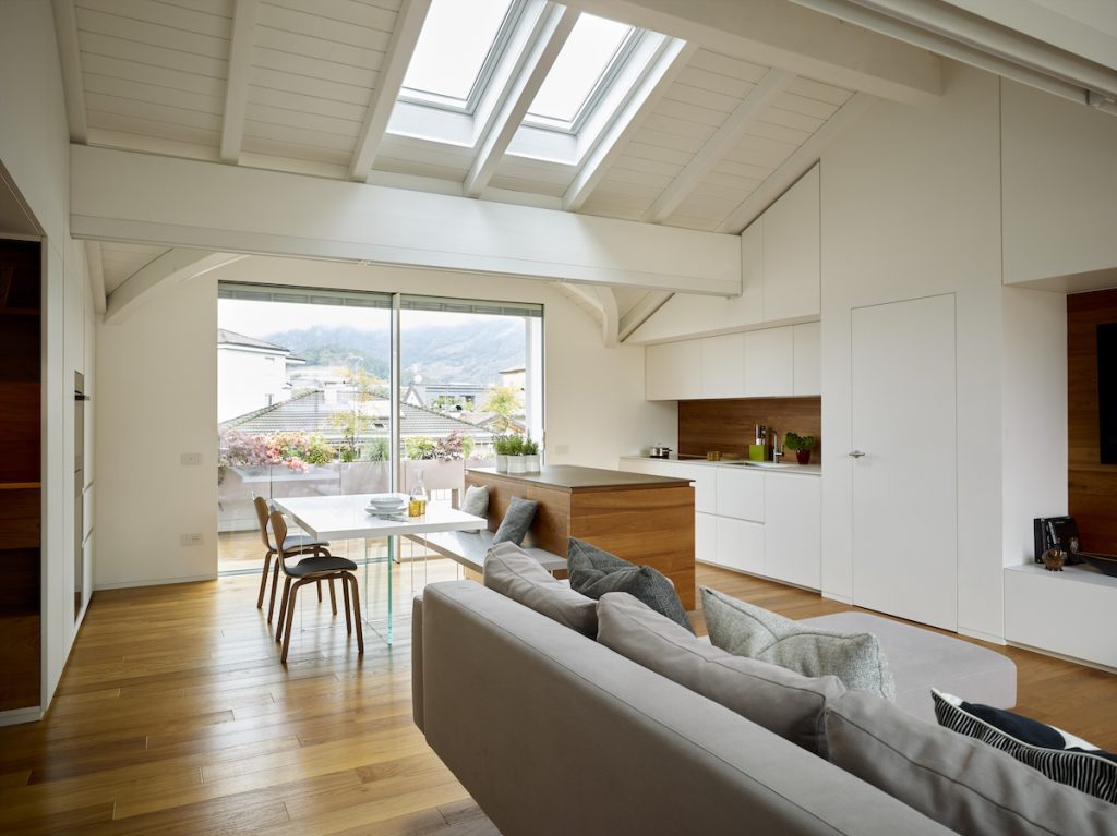 Strešný byt s bielym dreveným krovom a terasou
