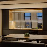 Podsvietená moderná hnedá kuchyňaso zrkadlovou zástenou
