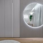 Moderná dizajnová spálňa s veľkým zrkadlom v béžových odtieňoch