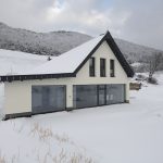 Malý biely dom s presklením pod kopcami Rajeckých hôr
