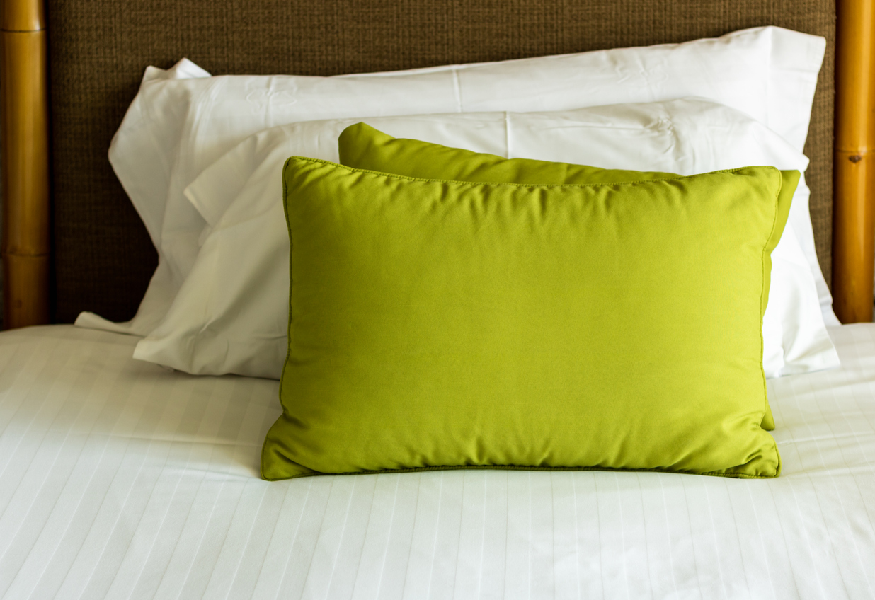 Green and White pillows on a bed Comfortable soft pillows on the bed