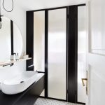 Kúpeľňa s umývadlom oddeleným od sprchovacieho kúta matnou presklenou stenou