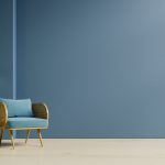 Interior design of living room with armchair on empty dark blue wall background.