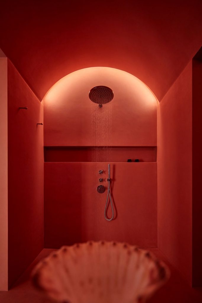 Dočervena sfarbená kúpeľňa so sprchovacím kútom.