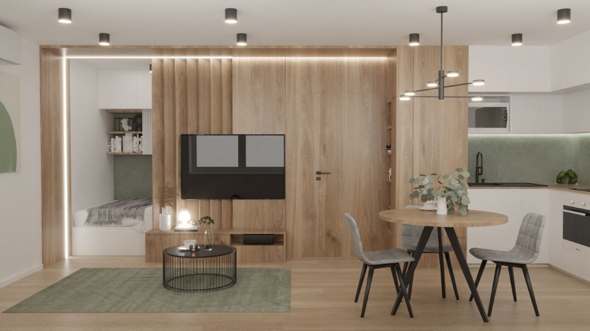 Časť moderného interiéru s kuchynským kútikom televízorom a priestorom na spanie.