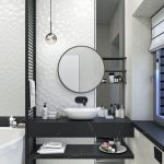 Moderná kúpeľňa s okrúhlym zrkadlom a umývadlom na tmavom pulte s doplnkami.