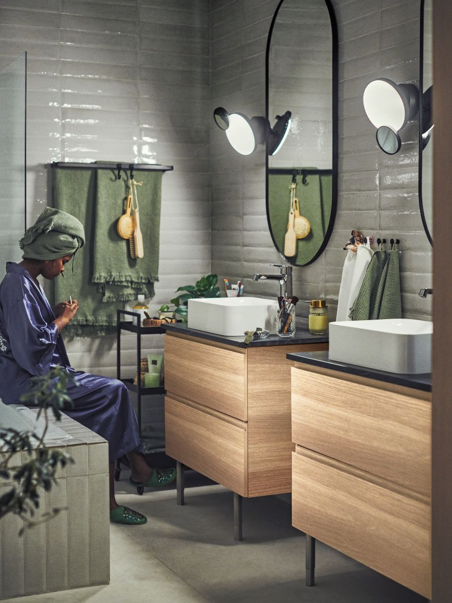 Moderná kúpeľňa s dvoma umývadlami, veľkými zrkadlami a prírodnými dekoráciami.