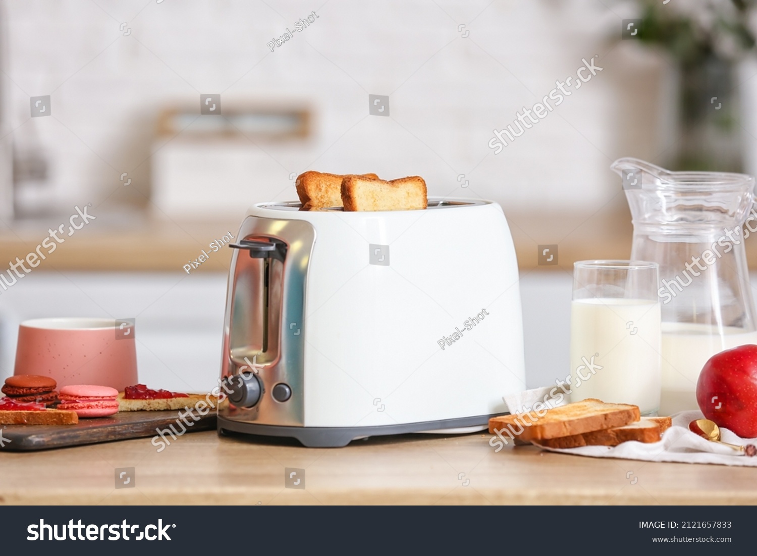 Stock-photo-white-toaster-with-tasty-food-and-drink-on-table-in-modern-kitchen-2121657833