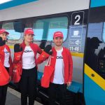Mladí ľudia mávajúci pri vlaku České dráhy,.