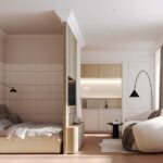 Interiér moderného apartmánu s posteľou, kuchynským kútom a oblou sedačkou.