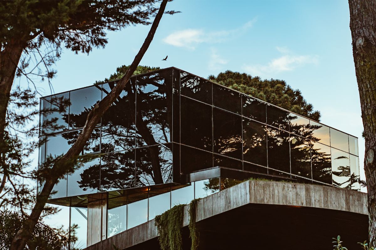 Architekti si pre horné poschodie zvolili fasádu z reflexného skla. 
