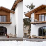 Vila s exteriérom alpských chát a bielou fasádou a dreveným obkladom.