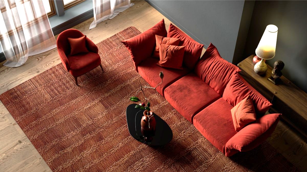 Oranžová zamatová sedačka s olivovou dekou, drevený stolík a krémová stena s čiernymi rámami obrazov.