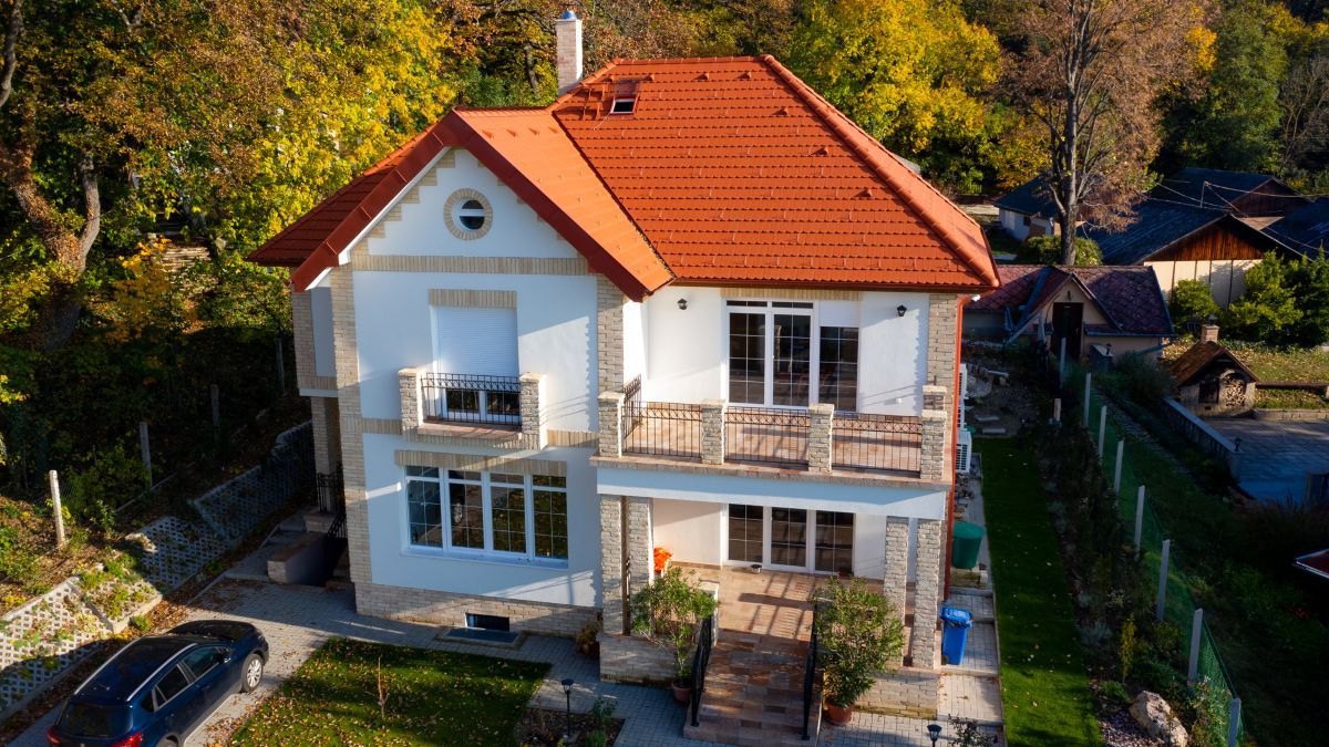 Zrekonštruovaná stará vila so zložitou škridlovou strechou.