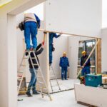 Robotníci pri práci v interiéri stavby domu.